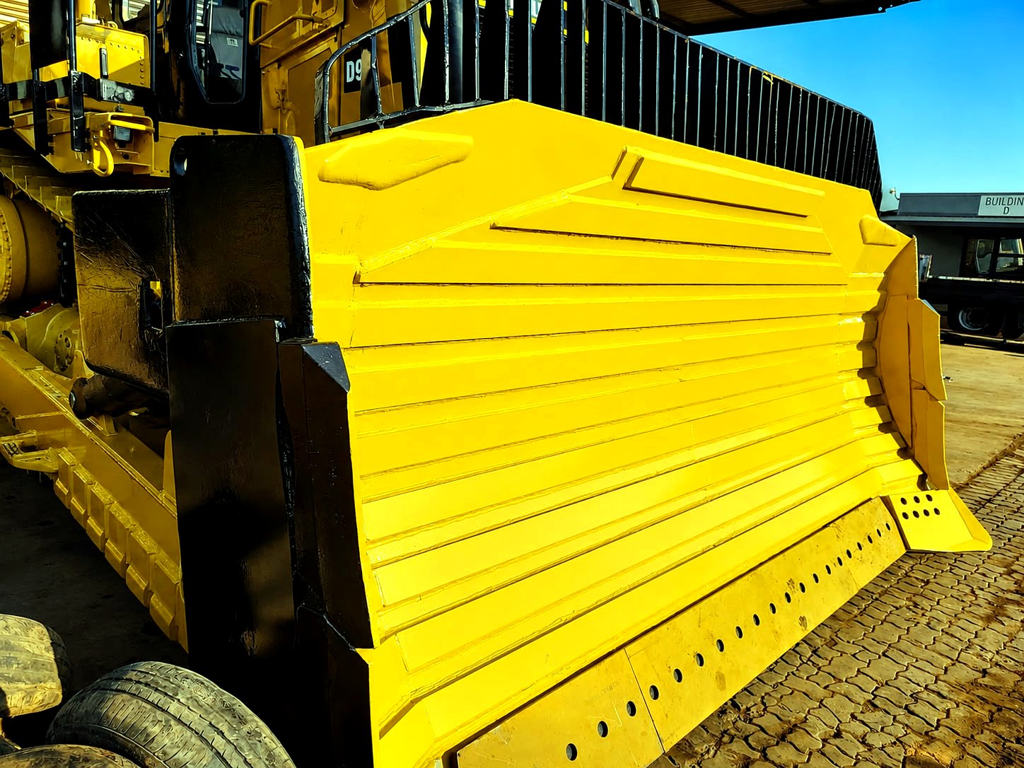 Dozer blade blasted and refinished in machine yellow